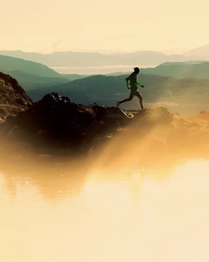 Runner moving across a mountain trail